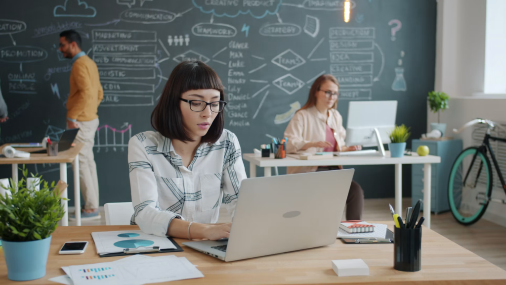 Team working on laptops in a modern office environment